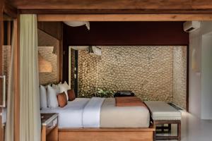 a bedroom with a large bed in a room at Seminyak Sanctuary Villa by Ini Vie Hospitality in Seminyak +38 photos