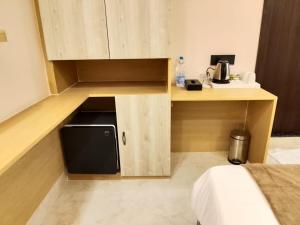 a small kitchen with a microwave in a room at Hotel Gulmohar Tree in Jāmb