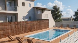a swimming pool on a deck with chairs and a house at Ilias Village in Skiathos