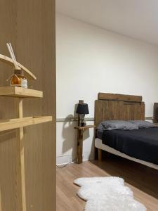 a bedroom with a bed and a white rug at Le saint pierre in Pontarlier