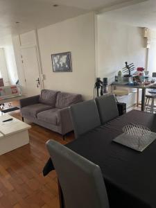 a living room with a couch and a table at Le saint pierre in Pontarlier +58 photos