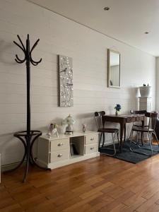a living room with a table and a dining room at Le saint pierre in Pontarlier