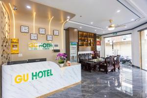 a store with a ciq hotel sign on the wall at Gu Boutique Hotel - Central Phan Rang in Phan Rang–Tháp Chàm