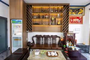 a room with a table and a shelf with bottles at Gu Boutique Hotel - Central Phan Rang in Phan Rang–Tháp Chàm