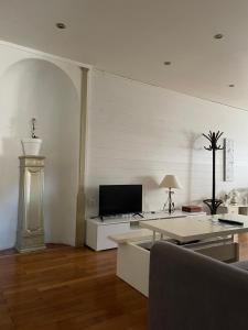 a living room with a couch and a tv at Le saint pierre in Pontarlier