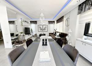 a living room with a long table and chairs at Serenity Hideaway Hisarönü in Fethiye