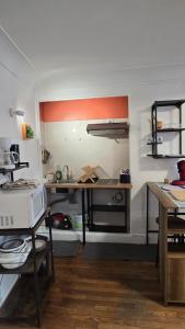 a kitchen with a desk and a microwave in it at Château Walk Studio Appartement in Fontainebleau