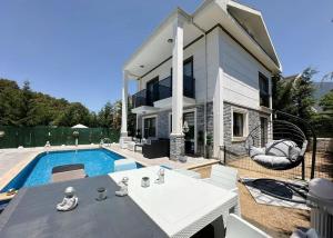 a house with a swimming pool in front of it at Serenity Hideaway Hisarönü in Fethiye