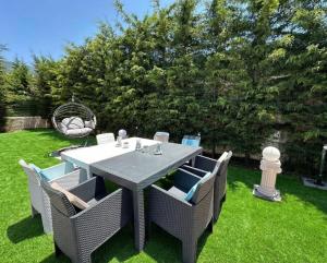 a dining table and chairs in a yard at Serenity Hideaway Hisarönü in Fethiye