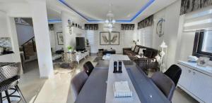 a living room with a large table and chairs at Serenity Hideaway Hisarönü in Fethiye