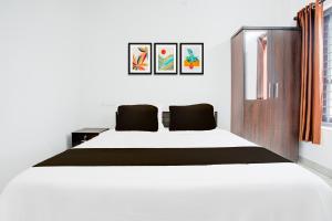 a bedroom with a large bed in a room at Hotel O D'Rooms in Trivandrum +21 photos