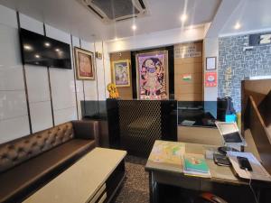 a waiting room with a couch and a table at The Mansion Courtyard in Mathura +6 photos