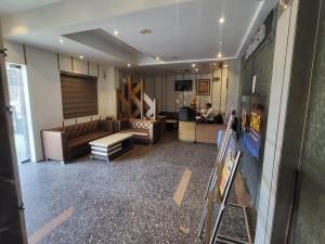a room with couches and a desk in a building at The Mansion Courtyard in Mathura