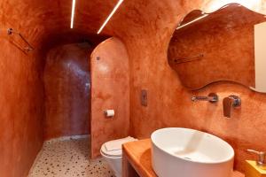 a bathroom with a sink and a toilet at Mardanza Krokos Suites in Imerovigli +65 photos