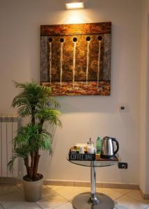 a table in a room with a painting on the wall at Suite 64 in Saviano