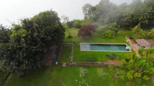 an aerial view of a yard with a swimming pool at Isla's Ridge - A CGH Earth SAHA Experience in Kodaikānāl