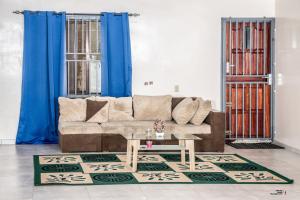 a living room with a couch and a table at Rijsdijk appartementen in Lelydorp