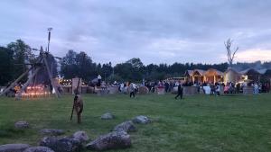 a group of people standing in a field with a crowd at Avoti in Jūrkalne