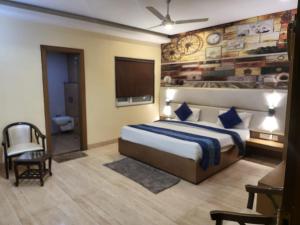 a hotel room with a bed and a television at The Mansion Courtyard in Mathura