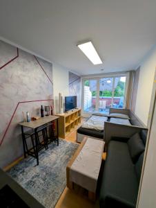 a living room with a couch and a table at Entspannen in Passau an der Donau inklusive Netflix in Passau