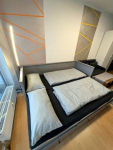 a bed with two pillows on it in a room at Entspannen in Passau an der Donau inklusive Netflix in Passau
