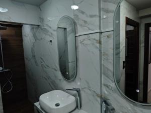 a bathroom with a sink and a mirror at Under the rocks luxury in Kalabaka +27 photos