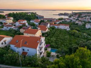 a view of a small town at sunset at Apartments Padovan in Rab +39 photos