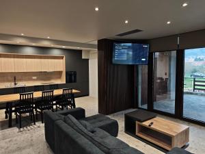 a living room with a couch and a table at Under the rocks luxury in Kalabaka