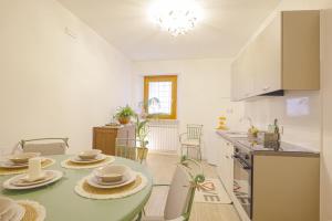 a kitchen with a table with plates and dishes on it at Alloggio turistico Alla Vasca in Tregnago