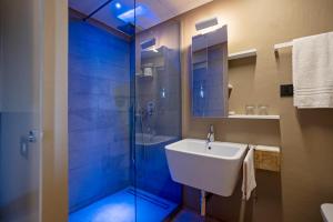 a bathroom with a sink and a shower at Rara Factory Design House in Orvieto