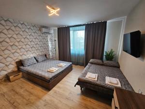 a living room with two beds and a couch at къща Чипровка in Chiprovtsi