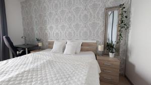 a bedroom with a white bed and a mirror at Sunset stay - Stunning views & Romantic Experience Option in Bratislava