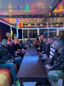 a group of people sitting around a long table at Ami d'or Hostel in Taghazout