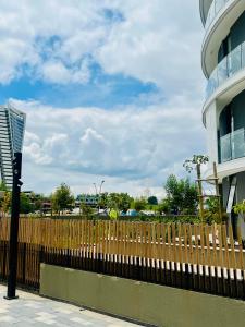 a wooden fence in front of a building at Executive Studio at Ellipse Galileo - Waterfall in Midrand +5 photos