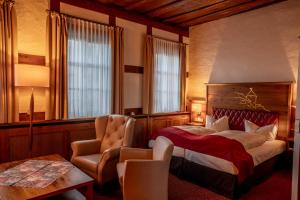 a hotel room with a bed and a chair at Burg Colmberg Hotel in Colmberg +174 photos