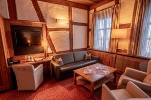 a living room with a couch and a table at Burg Colmberg Hotel in Colmberg