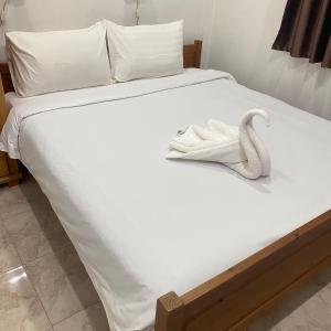 a white towel on a bed with a swan on it at Good Villa by Saran in Krabi