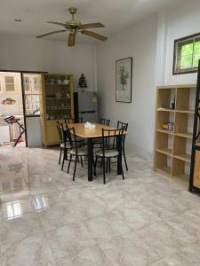 a dining room with a table and chairs at Good Villa by Saran in Krabi