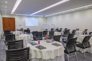 a conference room with tables and chairs and a screen at فندق ترى النزهة -Tura Hotel AlNuzha in Riyadh +11 photos