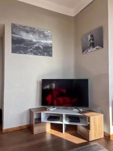 a living room with a large flat screen tv at Grand T3-CLIM-WIFI-Vue in Toulon