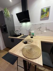 a kitchen with a wooden table with a sink at All in relaxation in Toulouse