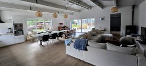 a large living room with a couch and a table at vakantiehuis 't Loreem in Geraardsbergen