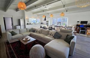 a living room with couches and a table and a kitchen at vakantiehuis 't Loreem in Geraardsbergen