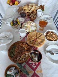 a table topped with bowls of food and other foods at Alban MAGZHAN in Saty