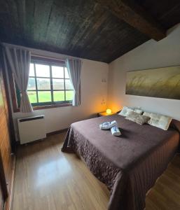 a bedroom with a bed and a large window at Camiño da Vieira in Padrón +51 photos