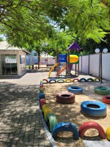 a playground in a park with a play equipment at Ap Clube Piçarras in Piçarras