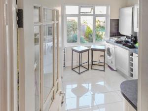 a white kitchen with a sink and a dishwasher at 3-Bed Duplex Flat, Free WIFI & Great Transport Links in Norwood +7 photos