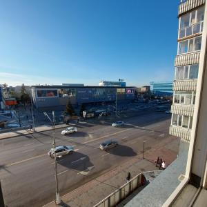 a view of a city street with cars and a building at Абзал in Karagandy