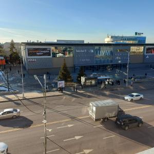 a busy city street with cars and a building at Абзал in Karagandy