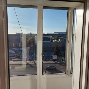 an open window with a view of a city at Абзал in Karagandy +2 photos